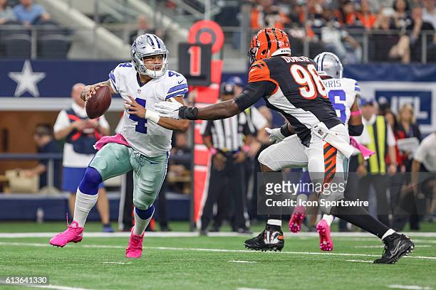 Dallas Cowboys Quarterback Dak Prescott is pressured by Cincinnati Bengals Defensive End Carlos Dunlap during the NFL game between the Cincinnati...