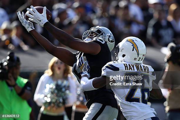 Michael Crabtree of the Oakland Raiders scores on a 21-yard pass against the San Diego Chargers during their NFL game at Oakland-Alameda County...