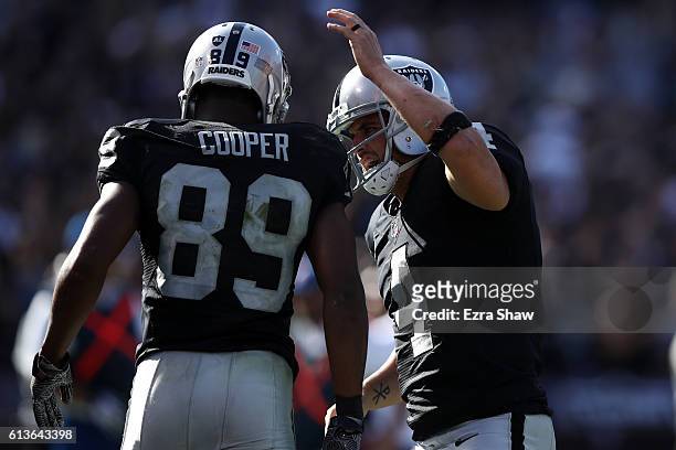 Derek Carr of the Oakland Raiders celebrates with Amari Cooper after a scoring on a two-point conversion against the San Diego Chargers during their...