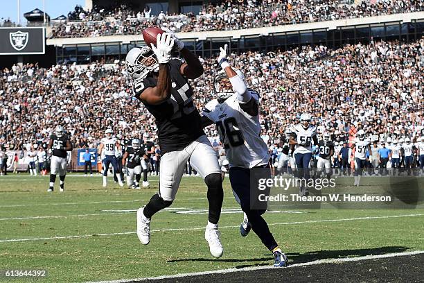 Michael Crabtree of the Oakland Raiders scores on a 21-yard pass against the San Diego Chargers during their NFL game at Oakland-Alameda County...