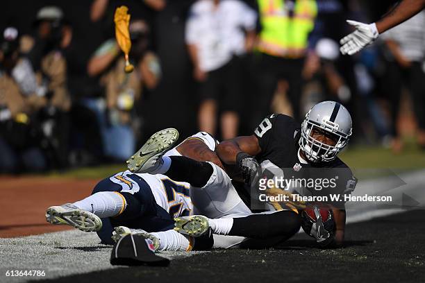 Amari Cooper of the Oakland Raiders catches the ball in the endzone against the San Diego Chargers during their NFL game at Oakland-Alameda County...