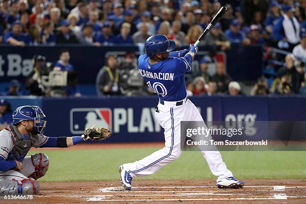 Edwin Encarnacion of the Toronto Blue Jays hits a two run home run in the first inning against the Texas Rangers during game three of the American...