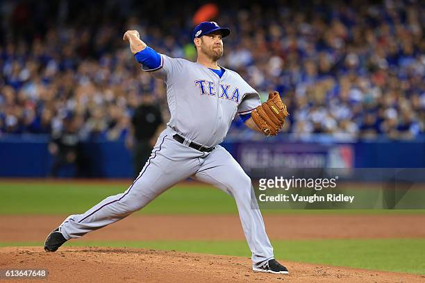Colby Lewis of the Texas Rangers works against the Toronto Blue Jays in the first inning during game three of the American League Division Series at...