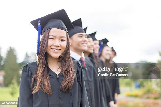 gruppe von studenten in abschlusskleidern - high school graduation stock-fotos und bilder