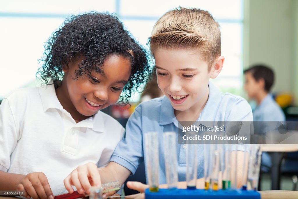 Cheerful STEM school students work on science experiment