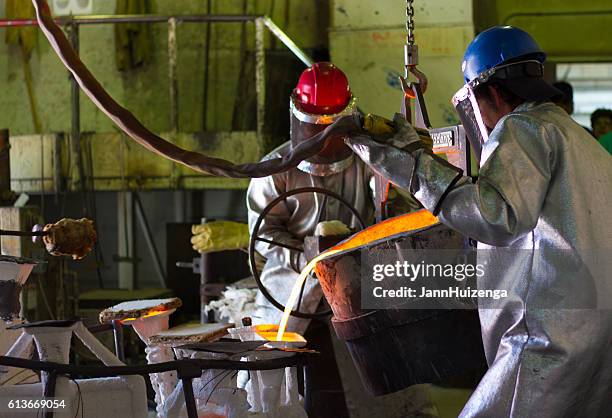 santa fe, nm: workers pouring bronze at shidoni foundry - foundry worker stock pictures, royalty-free photos & images