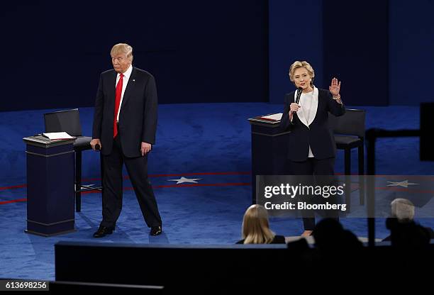 Hillary Clinton, 2016 Democratic presidential nominee, speaks as Donald Trump, 2016 Republican presidential nominee, stands during the second U.S....