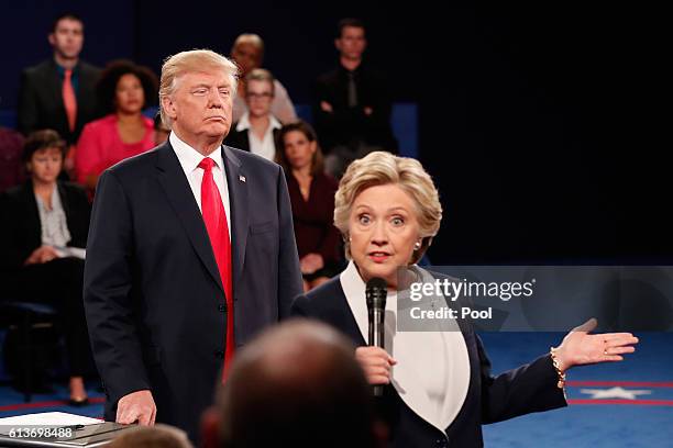 Democratic presidential nominee former Secretary of State Hillary Clinton speaks as Republican presidential nominee Donald Trump looks on during the...