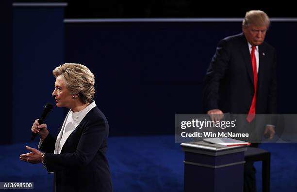 Democratic presidential nominee former Secretary of State Hillary Clinton speaks as Republican presidential nominee Donald Trump looks on during the...