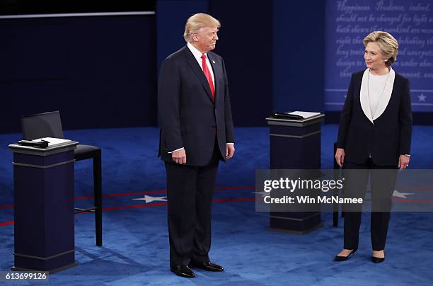 Republican presidential nominee Donald Trump and Democratic presidential nominee former Secretary of State Hillary Clinton stand on stage during the...