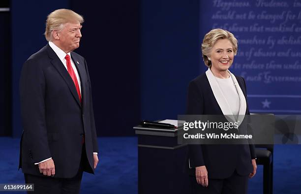 Republican presidential nominee Donald Trump and Democratic presidential nominee former Secretary of State Hillary Clinton stand on stage during the...