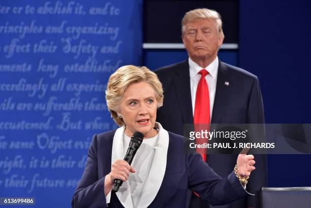 Republican presidential candidate Donald Trump listens to Democratic presidential candidate Hillary Clinton during the second presidential debate at...