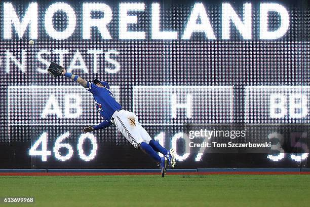 Kevin Pillar of the Toronto Blue Jays cannot reach a two run double hit by Mitch Moreland of the Texas Rangers in the sixth inning during game three...