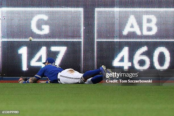 Kevin Pillar of the Toronto Blue Jays cannot reach a two run double hit by Mitch Moreland of the Texas Rangers in the sixth inning during game three...