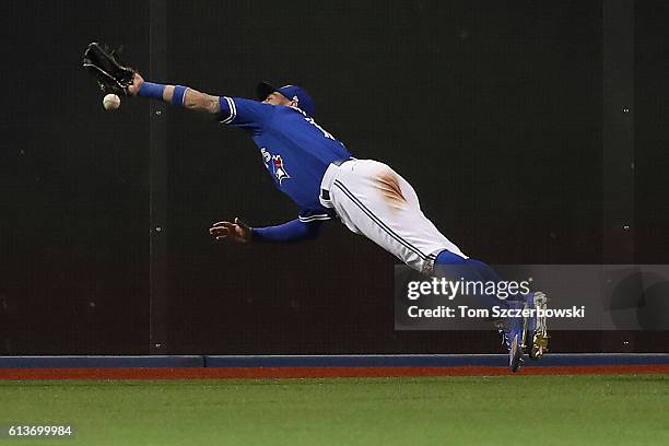 Kevin Pillar of the Toronto Blue Jays cannot reach a two run double hit by Mitch Moreland of the Texas Rangers in the sixth inning during game three...