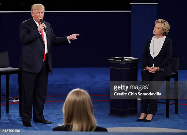 Republican presidential nominee Donald Trump points at Democratic presidential nominee former Secretary of State Hillary Clinton during the town hall...
