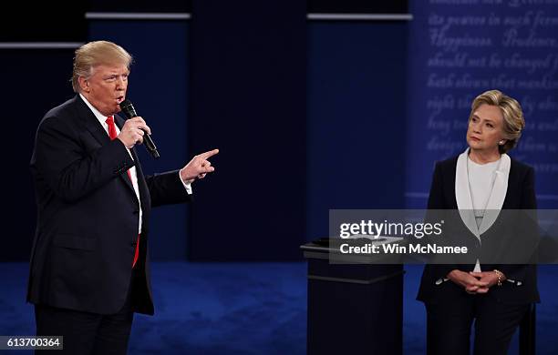 Republican presidential nominee Donald Trump speaks as Democratic presidential nominee former Secretary of State Hillary Clinton looks on during the...