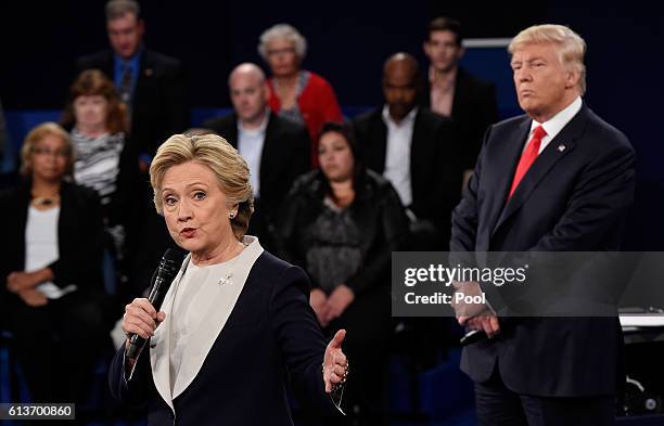 Democratic presidential nominee former Secretary of State Hillary Clinton speaks as Republican presidential nominee Donald Trump looks on during the...