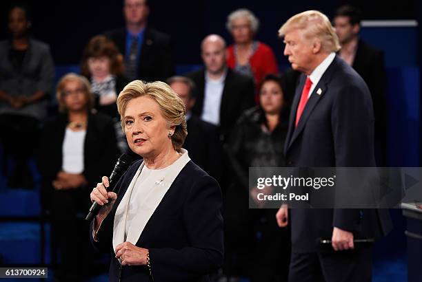 Democratic presidential nominee former Secretary of State Hillary Clinton speaks as Republican presidential nominee Donald Trump listens during the...