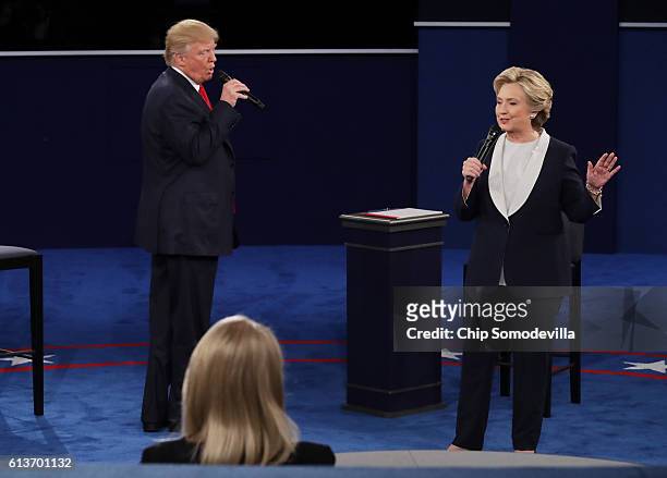 Democratic presidential nominee former Secretary of State Hillary Clinton speaks as Republican presidential nominee Donald Trump looks on during the...