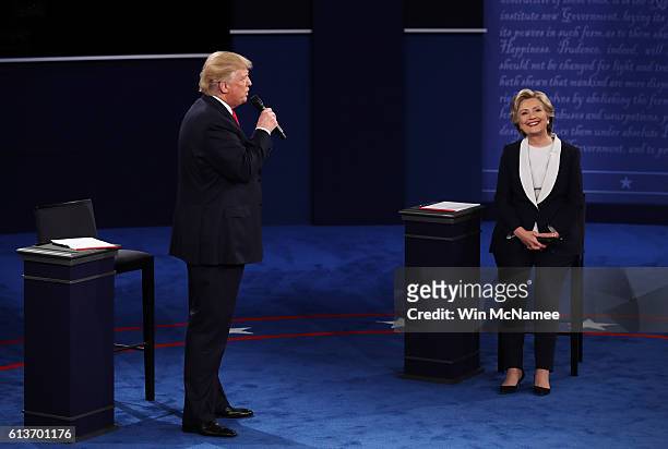 Republican presidential nominee Donald Trump speaks as Democratic presidential nominee former Secretary of State Hillary Clinton looks on during the...