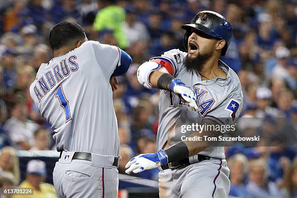 Rougned Odor of the Texas Rangers celebrates with teammate Elvis Andrus hitting a two run home run against the Toronto Blue Jays in the fourth inning...