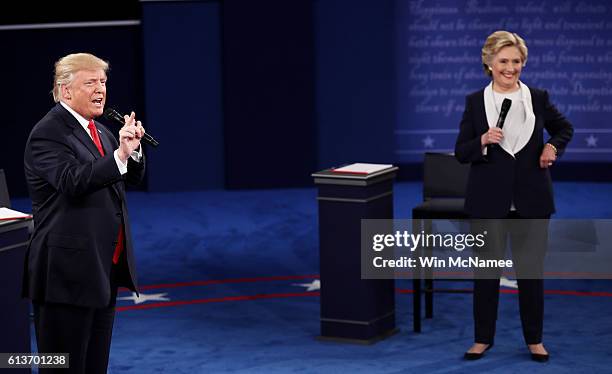 Republican presidential nominee Donald Trump speaks as Democratic presidential nominee former Secretary of State Hillary Clinton looks on during the...