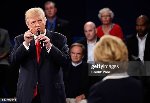 Republican presidential nominee Donald Trump speaks as Democratic presidential nominee former Secretary of State Hillary Clinton looks on during the...