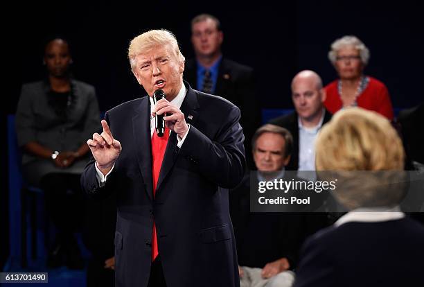 Republican presidential nominee Donald Trump speaks as Democratic presidential nominee former Secretary of State Hillary Clinton looks on during the...