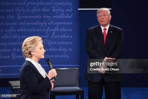 Democratic presidential nominee former Secretary of State Hillary Clinton speaks as Republican presidential nominee Donald Trump listens during the...