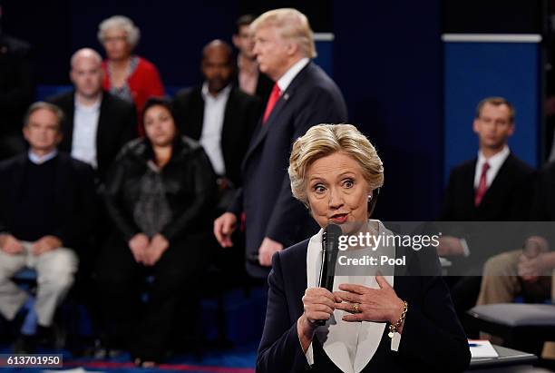 Democratic presidential nominee former Secretary of State Hillary Clinton speaks as Republican presidential nominee Donald Trump listens during the...