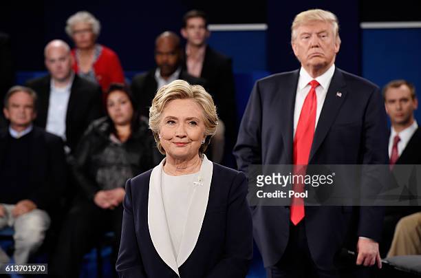 Democratic presidential nominee former Secretary of State Hillary Clinton and Republican presidential nominee Donald Trump listen during the town...