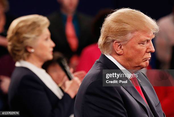 Democratic presidential nominee former Secretary of State Hillary Clinton speaks as Republican presidential nominee Donald Trump listens during the...