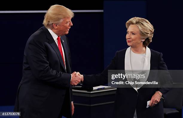 Republican presidential nominee Donald Trump shakes hands with Democratic presidential nominee former Secretary of State Hillary Clinton during the...