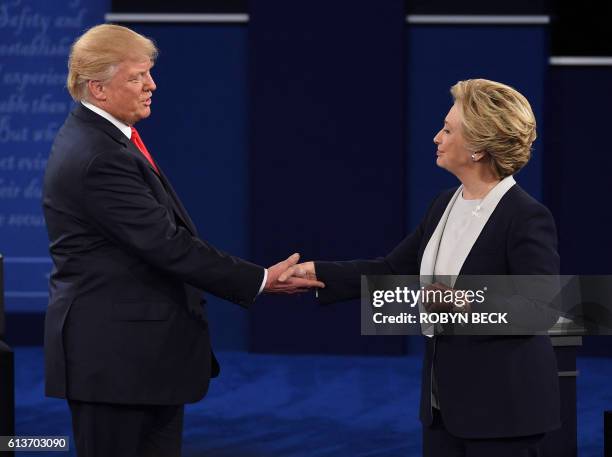 Democratic presidential candidate Hillary Clinton and US Republican presidential candidate Donald Trump shake hands at the end of the second...