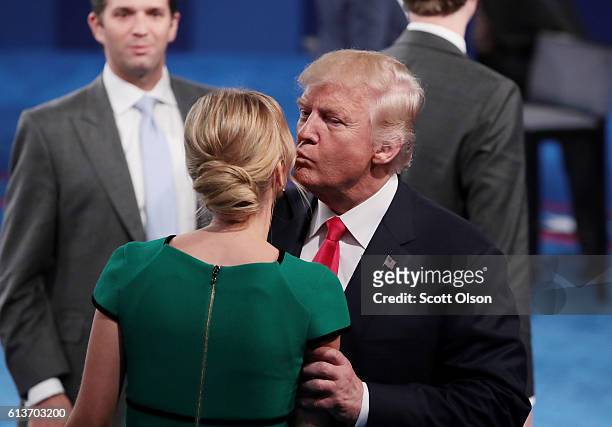 Republican presidential nominee Donald Trump kisses daughter Ivanka Trump during the town hall debate at Washington University on October 9, 2016 in...