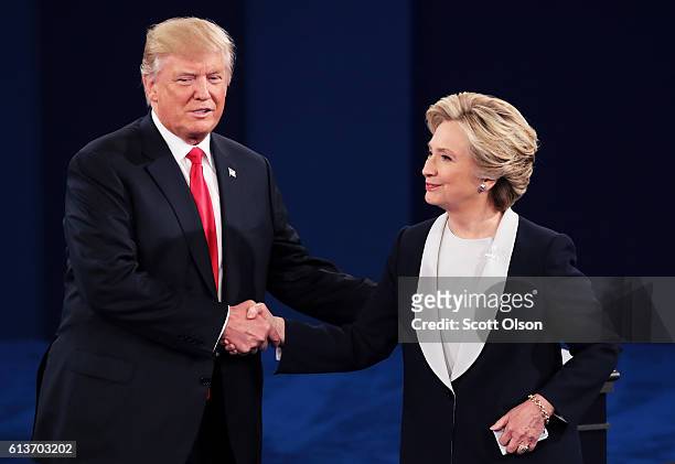 Republican presidential nominee Donald Trump shakes hands with Democratic presidential nominee former Secretary of State Hillary Clinton during the...