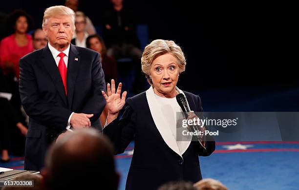 Democratic presidential nominee former Secretary of State Hillary Clinton speaks as Republican presidential nominee Donald Trump listens during the...