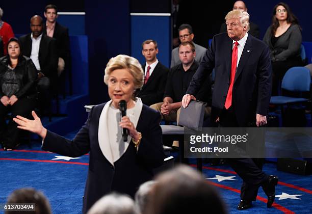 Democratic presidential nominee former Secretary of State Hillary Clinton speaks as Republican presidential nominee Donald Trump listens during the...