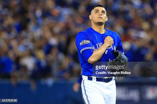 Roberto Osuna of the Toronto Blue Jays reacts after throwing a strike out against the Texas Rangers in the tenth inning during game three of the...