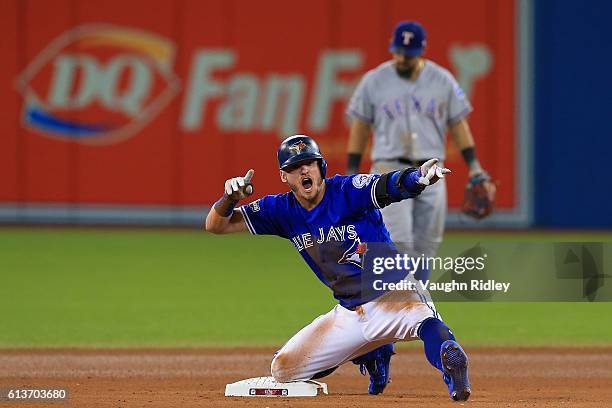 Josh Donaldson of the Toronto Blue Jays reacts after hitting a double in the tenth inning against the Texas Rangers during game three of the American...