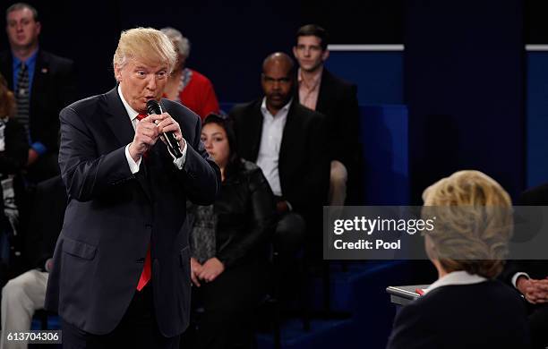 Republican presidential nominee Donald Trump speaks as Democratic presidential nominee former Secretary of State Hillary Clinton listens during the...