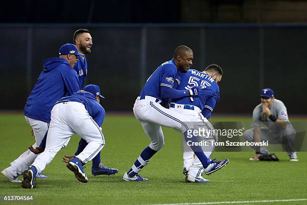 Melvin Upton Jr. #7 of the Toronto Blue Jays celebrates with teammate Russell Martin after the Toronto Blue Jays defeated the Texas Rangers 7-6...