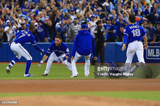 Melvin Upton Jr. #7 of the Toronto Blue Jays celebrates with teammate Russell Martin after the Toronto Blue Jays defeated the Texas Rangers 7-6...