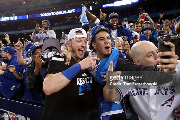Josh Donaldson of the Toronto Blue Jays celebrates with fans after the Toronto Blue Jays defeated the Texas Rangers 7-6 for game three of the...