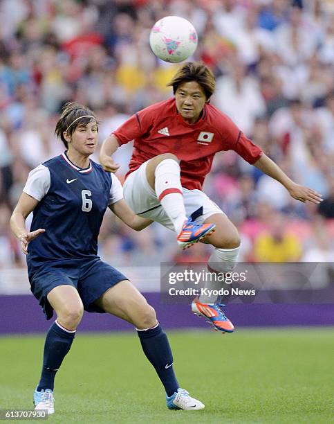 Britain - Japan's Shinobu Ono fights for the ball with Amy Le Peilbet of the United States during the first half of the women's soccer final at...
