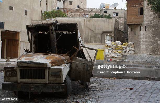 Free Syrian Army fighters stand at a bunker beyond a sniper alley in the Old City in Aleppo, Syria. It is estimated that 400,000 people have died in...