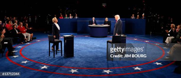 Democratic nominee Hillary Clinton and Republican nominee Donald Trump arrive on stage during the second presidential debate at Washington University...