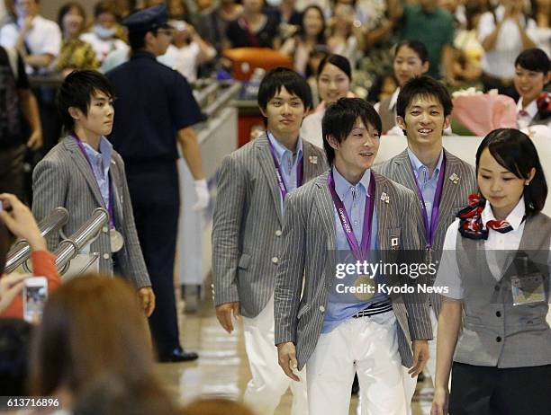 Japan - Members of the Japan men's gymnastics team Ryohei Kato, Yusuke Tanaka, Kohei Uchimura and Kazuhito Tanaka arrive at Narita International...