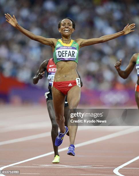 Britain - Ethiopia's Meseret Defar rejoices after finishing first in the women's 5,000 meters final at the Olympic Stadium at the 2012 London...